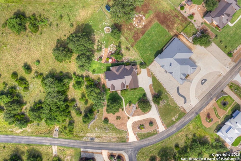 An aerial view of a house in a rural area.