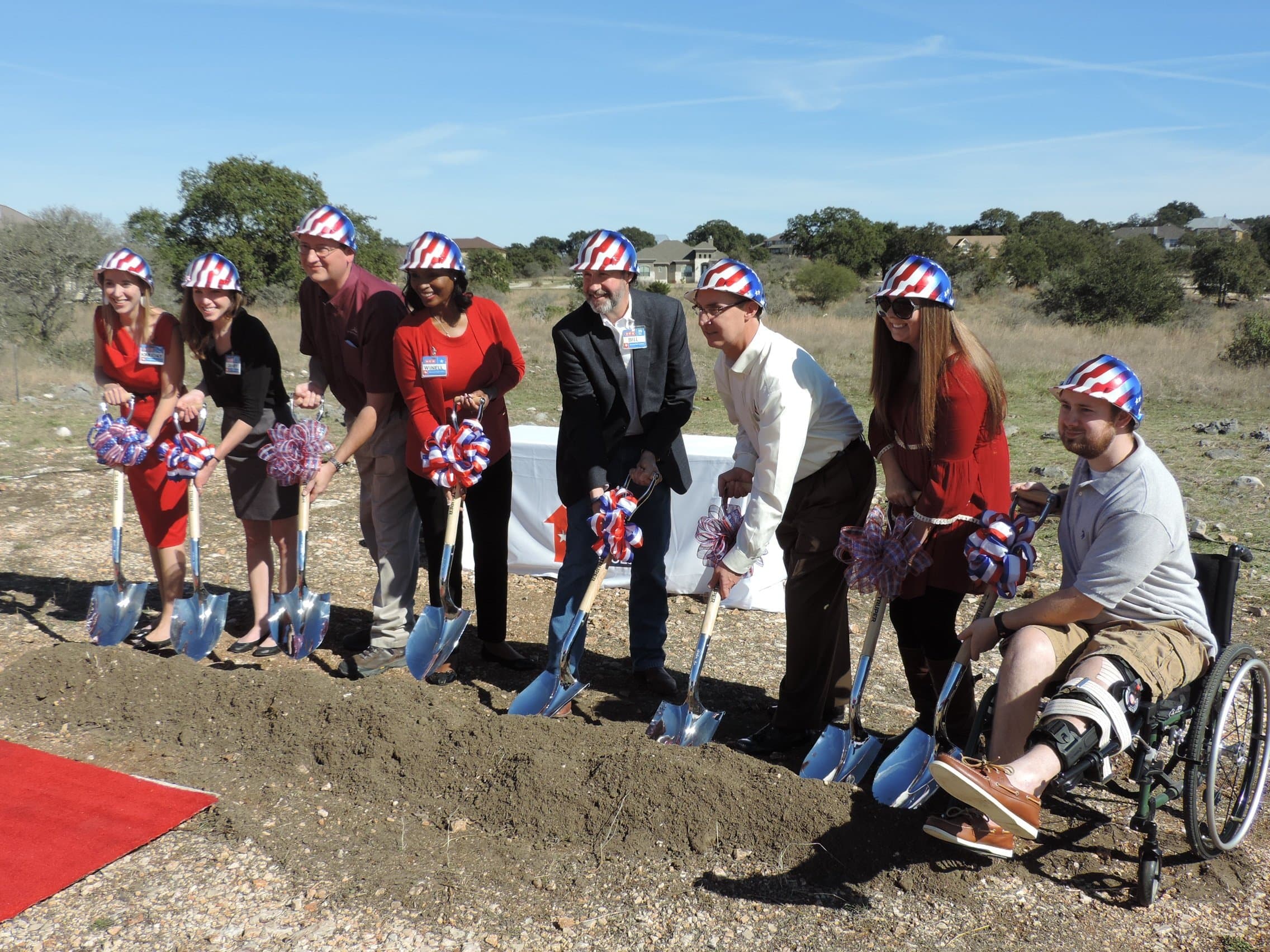 A group of people with shovels at a Veteran home site donated by Southstar.