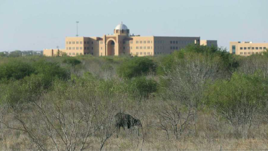 A large building in the middle of a grassy field in San Antonio