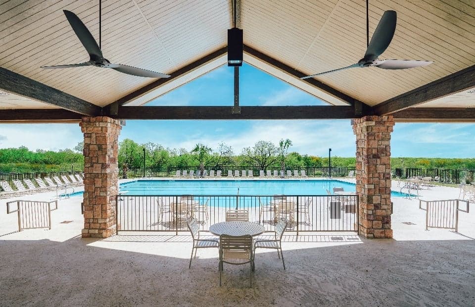 The Mission del Lago pool area with ceiling fans and patio furniture.