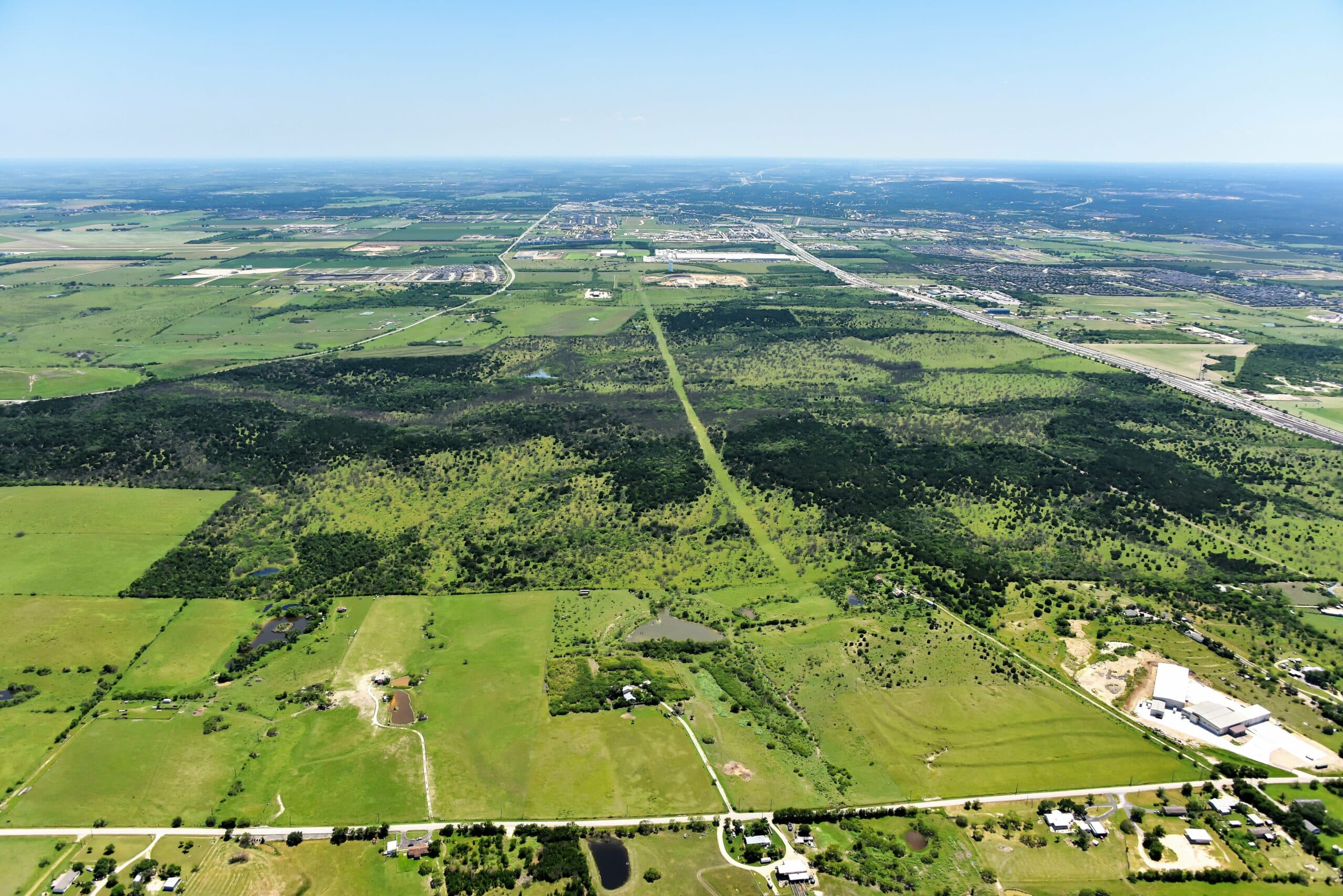 An aerial view of a farm and field at Mayfair in New Braunfels, Texas