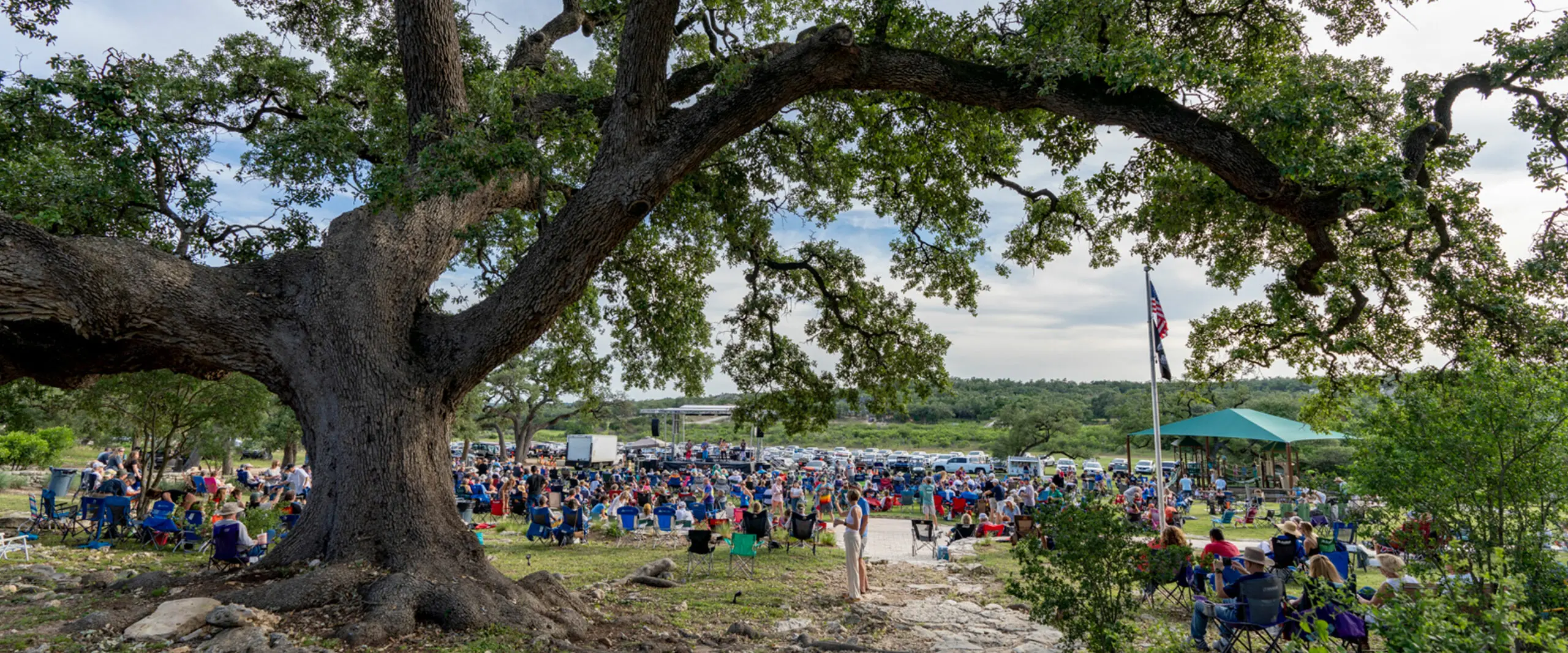 A large group of people gathered for an outdoor concert